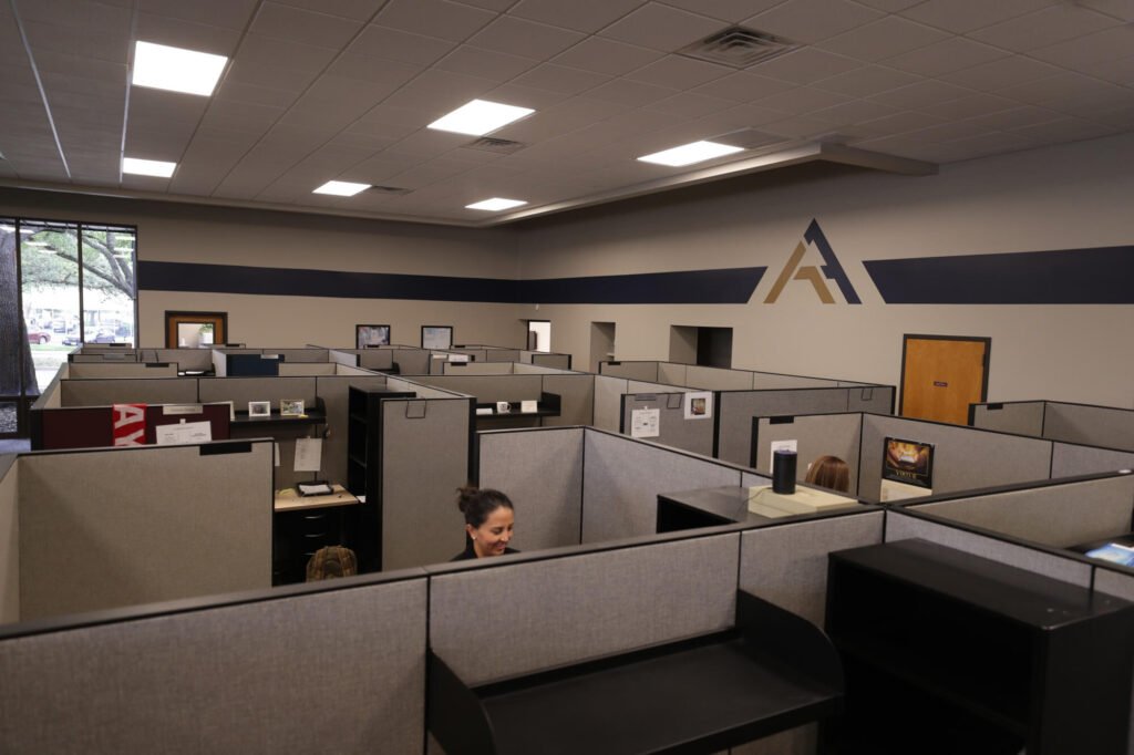 Atchley & Associates Austin office with workstations and the firm’s logo on the wall
