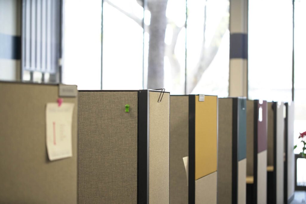 Row of office workstations beside large windows at Atchley & Associates