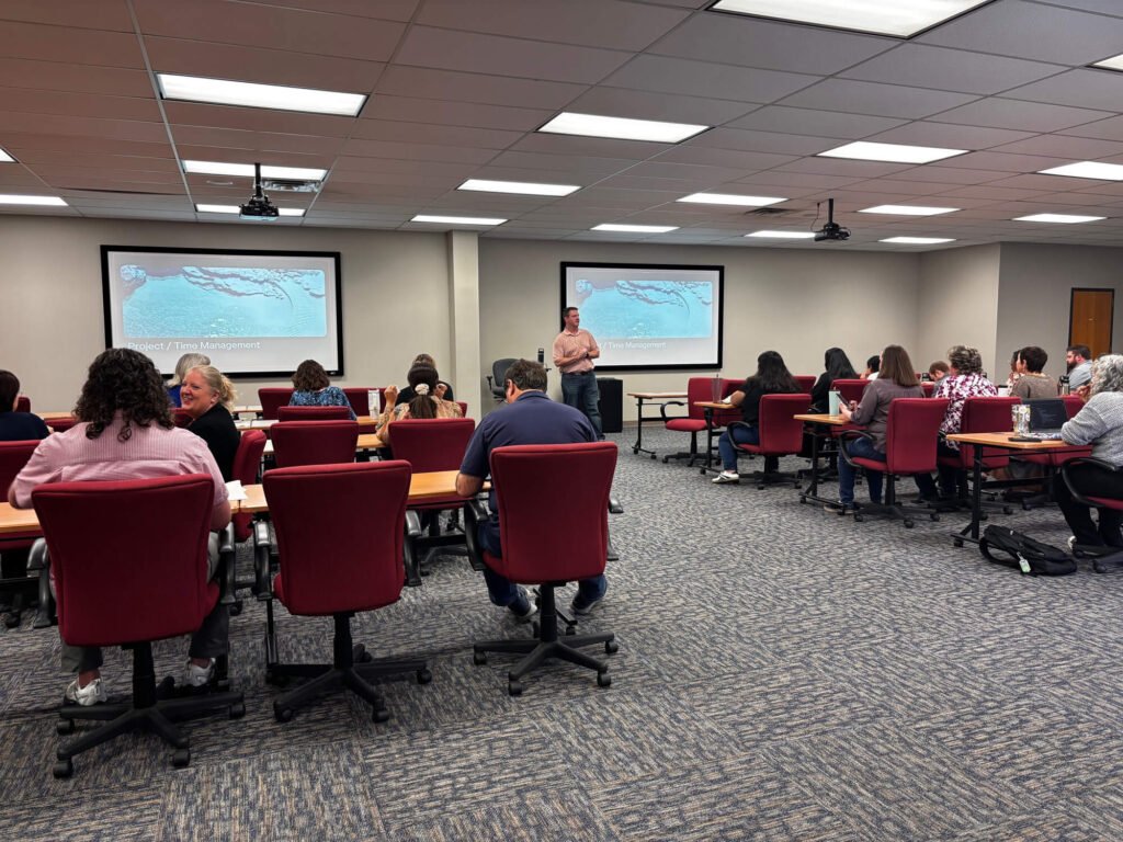 Atchley & Associates team members attending a presentation in a training room